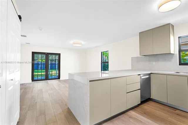 a kitchen with a sink cabinets and wooden floor