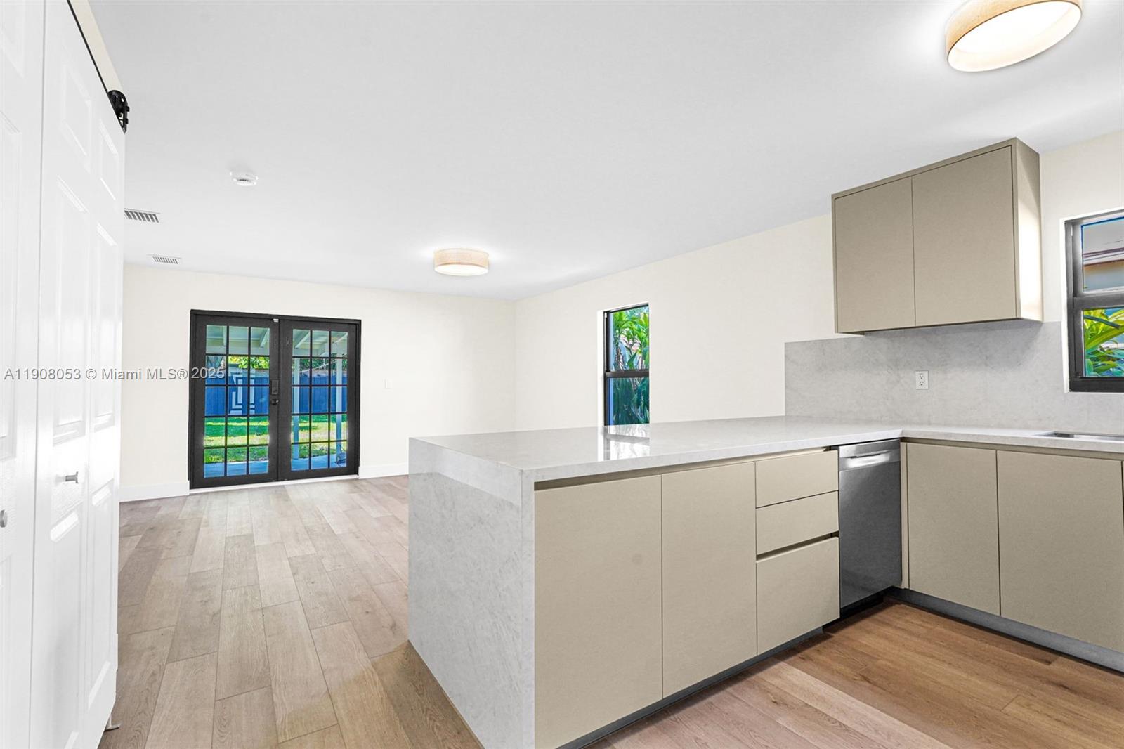 136 Northwest 53rd Street Miami, FL 33127 - Photo 7 of 28 a kitchen with a sink cabinets and wooden floor