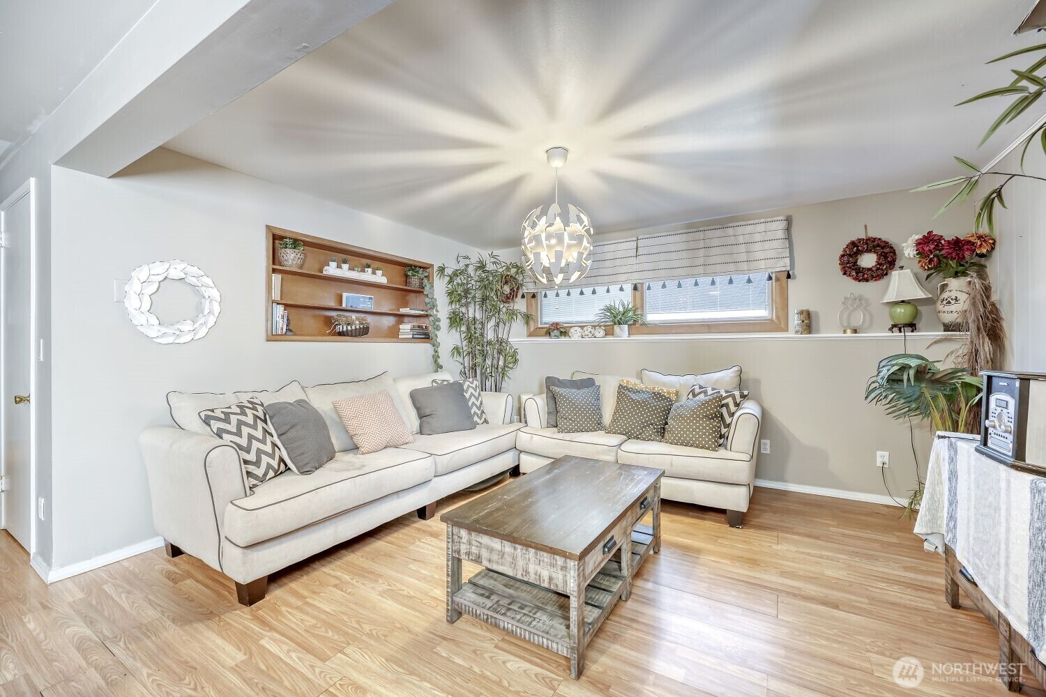 1401 Lake Youngs Way Southeast Renton, WA 98058 - Photo 11 of 27 a living room with furniture and a chandelier
