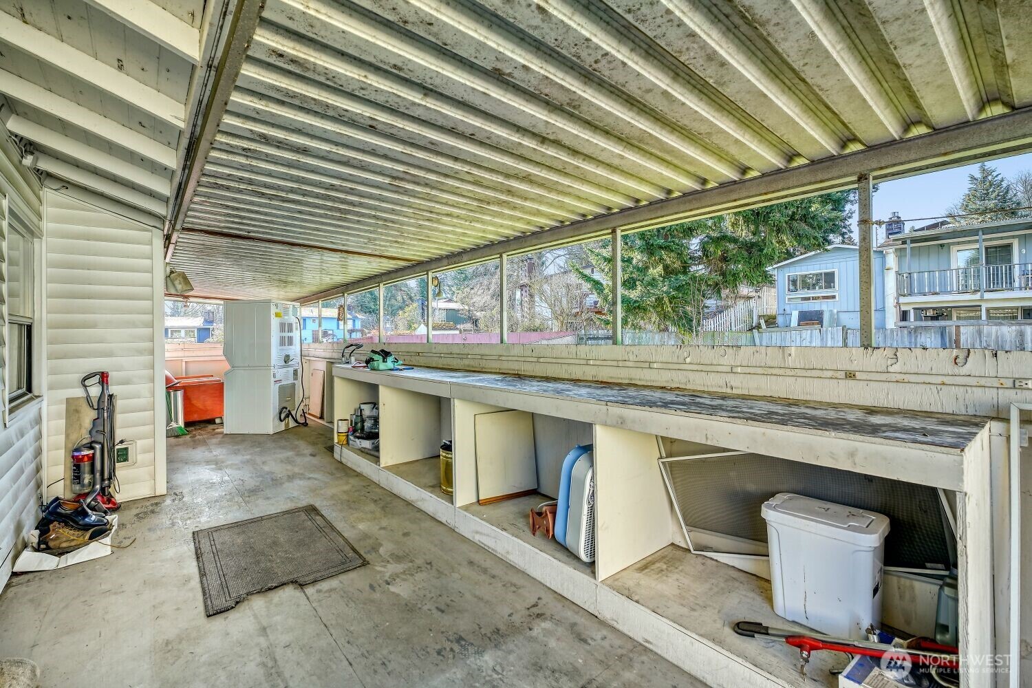 1401 Lake Youngs Way Southeast Renton, WA 98058 - Photo 23 of 27 a view of a patio with table and chairs under an umbrella