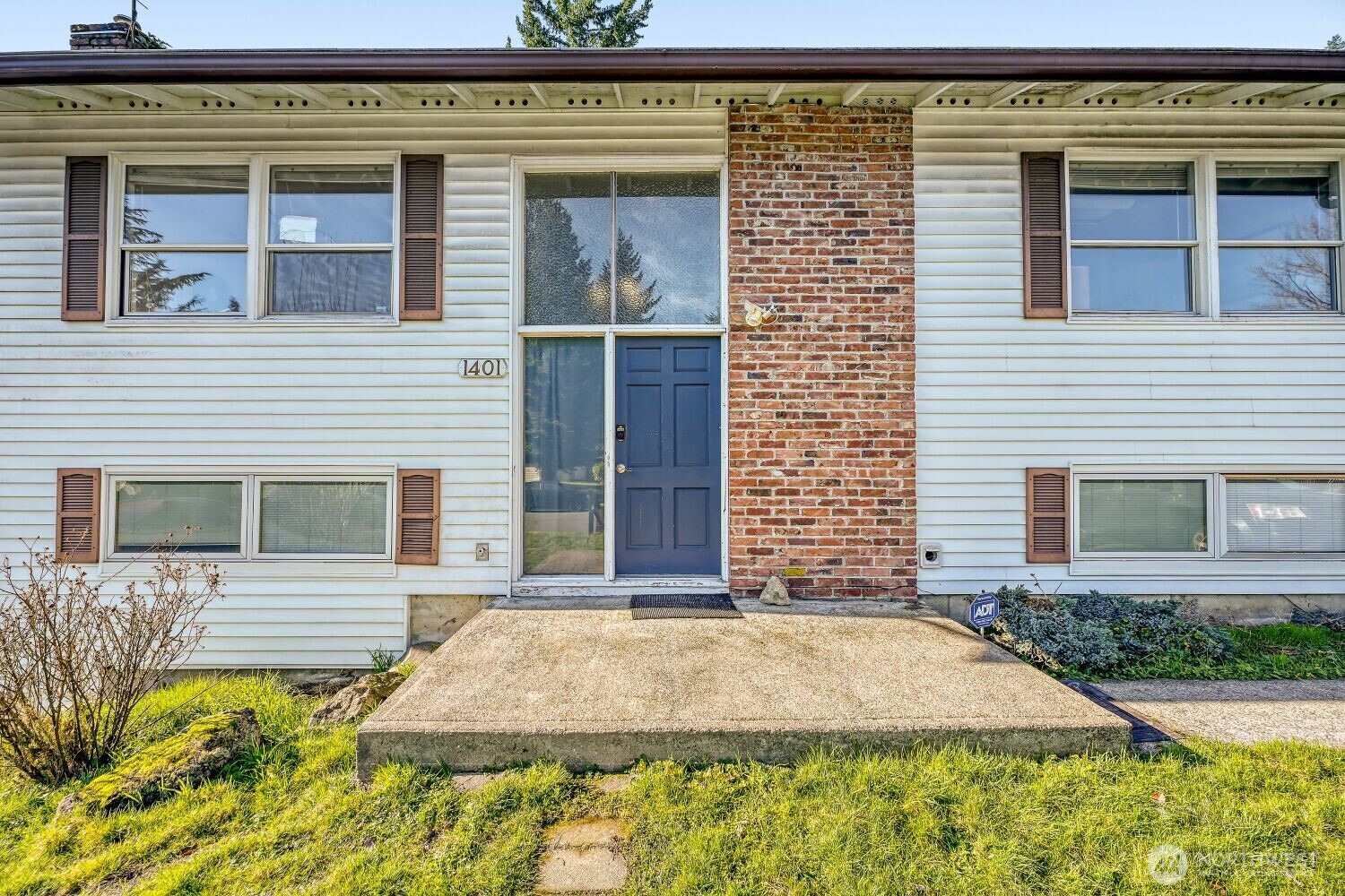 1401 Lake Youngs Way Southeast Renton, WA 98058 - Photo 3 of 27 a front view of a house with a yard