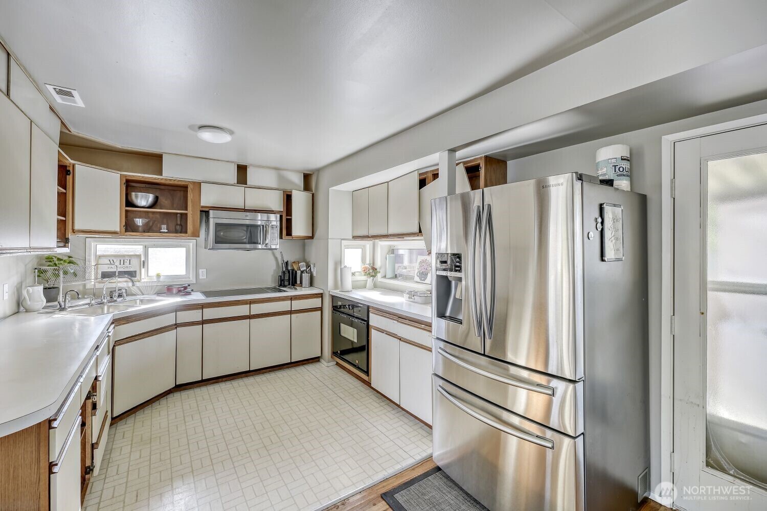 1401 Lake Youngs Way Southeast Renton, WA 98058 - Photo 6 of 27 a kitchen with stainless steel appliances a refrigerator sink and microwave