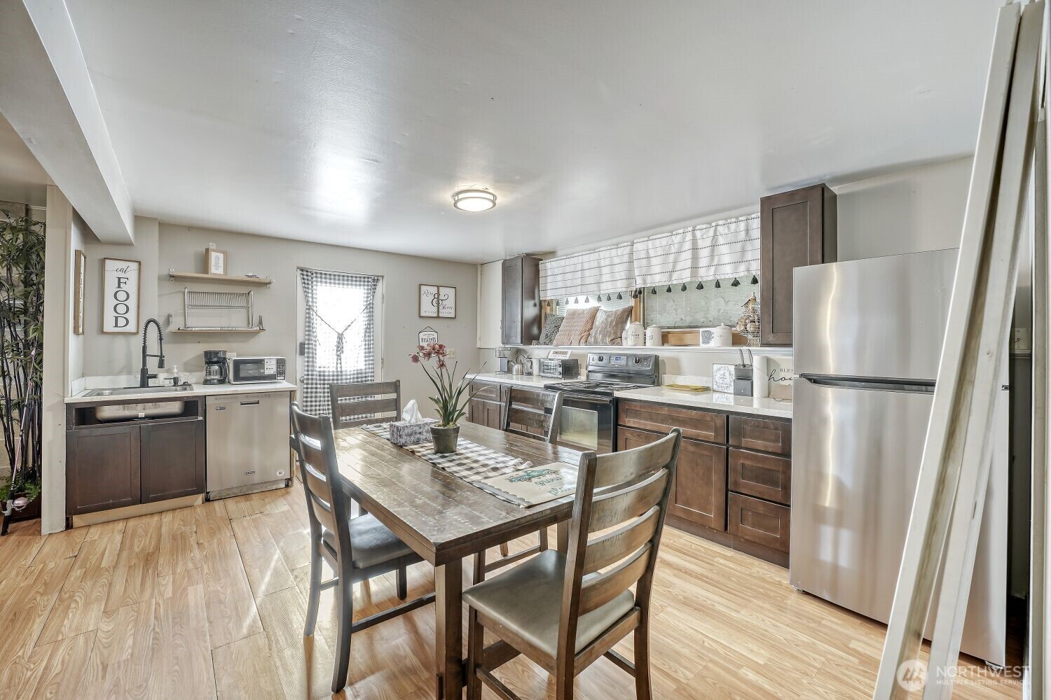1401 Lake Youngs Way Southeast Renton, WA 98058 - Photo 9 of 27 a kitchen with refrigerator a stove and wooden floor