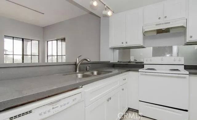 a kitchen with appliances cabinets and a sink