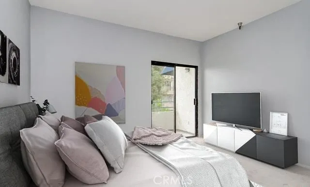 a bedroom with a bed and a flat screen tv