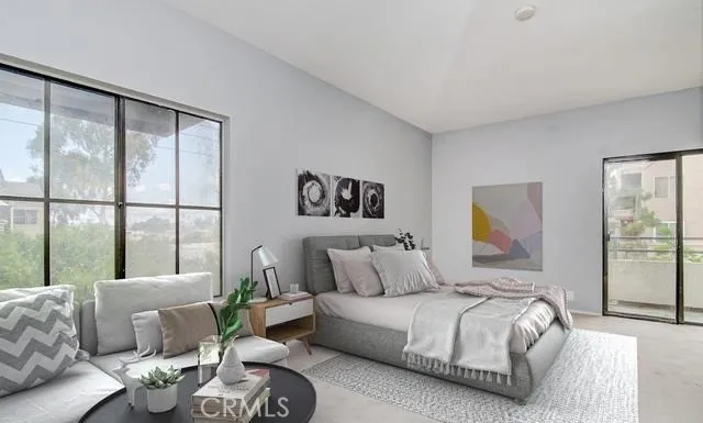 a bedroom with a bed and a large window