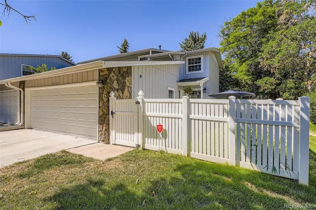 a front view of a house with wooden fence