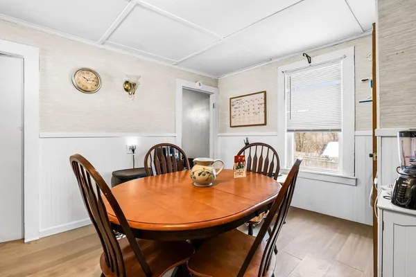 a view of a dining room with furniture and window