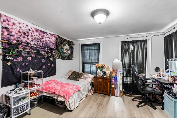 a bedroom with bed and a night stand