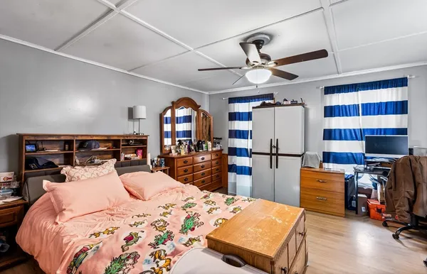 a bedroom with a bed a desk and chair