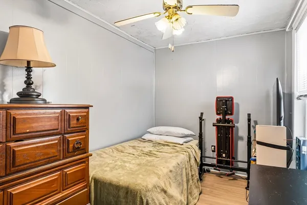 a bedroom with a bed and a chandelier