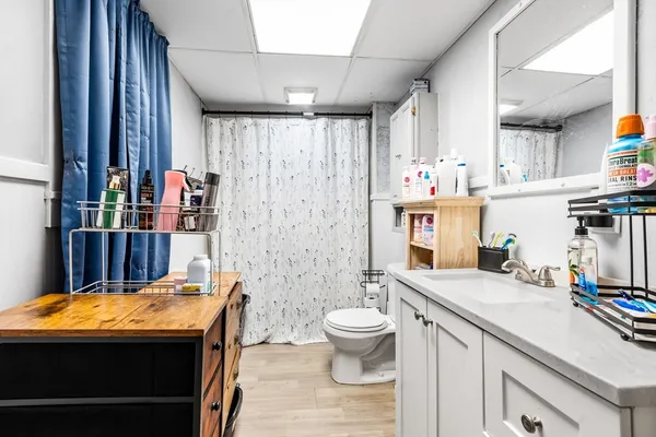 a room with stainless steel appliances kitchen island granite countertop a sink and cabinets