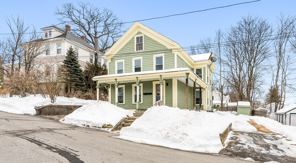 77 Wheeler Street Athol, MA 01331 - Photo 33 of 39 a view of a white house with a large tree next to a yard