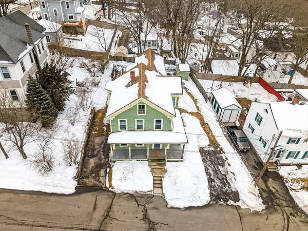 a view of a house with a yard covered with snow in the background