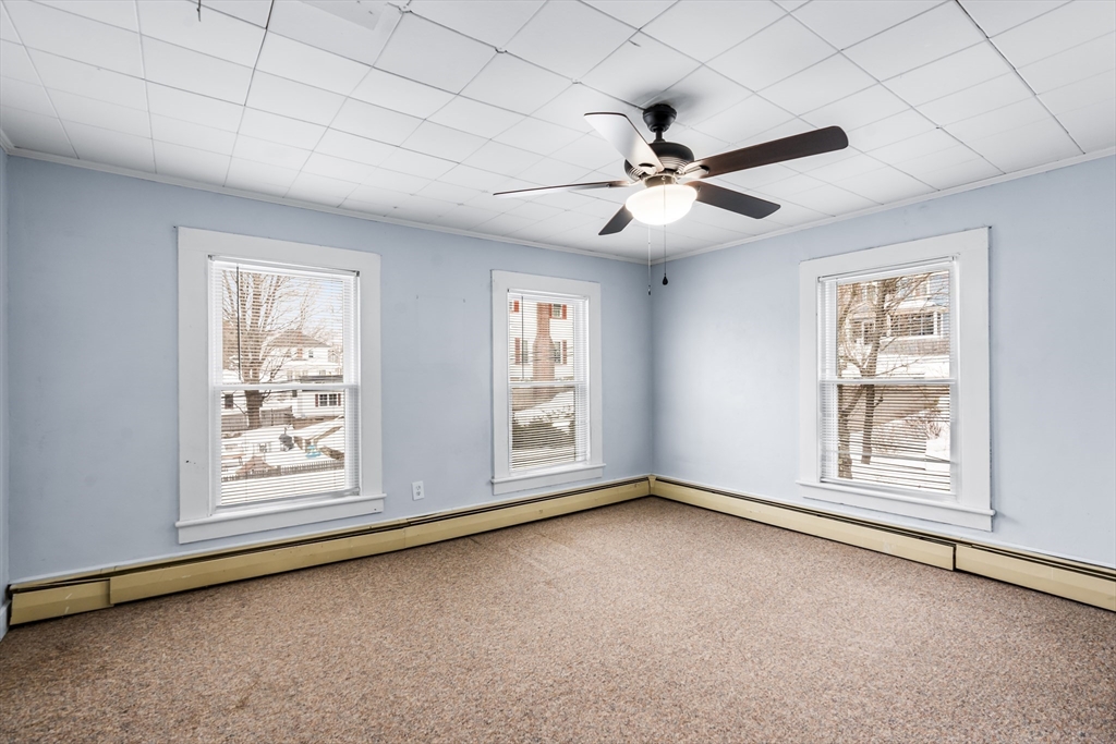 77 Wheeler Street Athol, MA 01331 - Photo 7 of 39 a view of an empty room with chandelier fan and fire place
