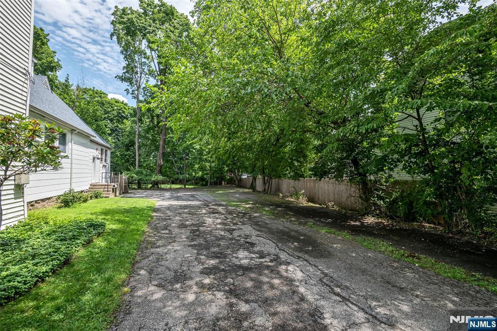 283 Harrington Avenue Closter, NJ 07624 - Photo 11 of 17 a backyard of a house with lots of green space