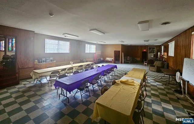 a room with furniture pool table and windows