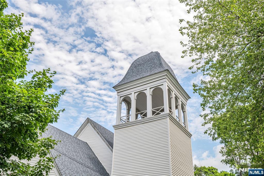 283 Harrington Avenue Closter, NJ 07624 - Photo 3 of 17 a front view of a house with a garden