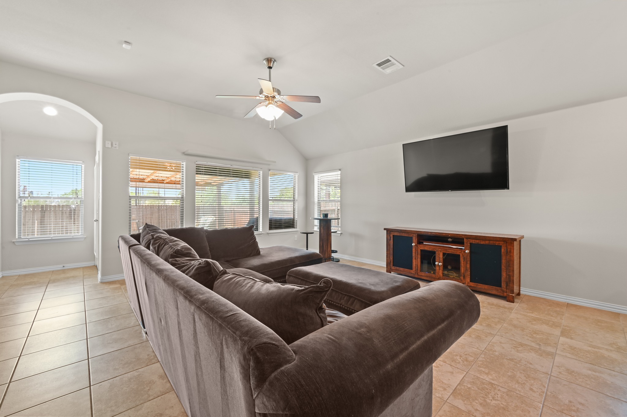 877 Hot Spring Valley Buda, TX 78610 - Photo 12 of 36 a living room with furniture a fireplace and a flat screen tv