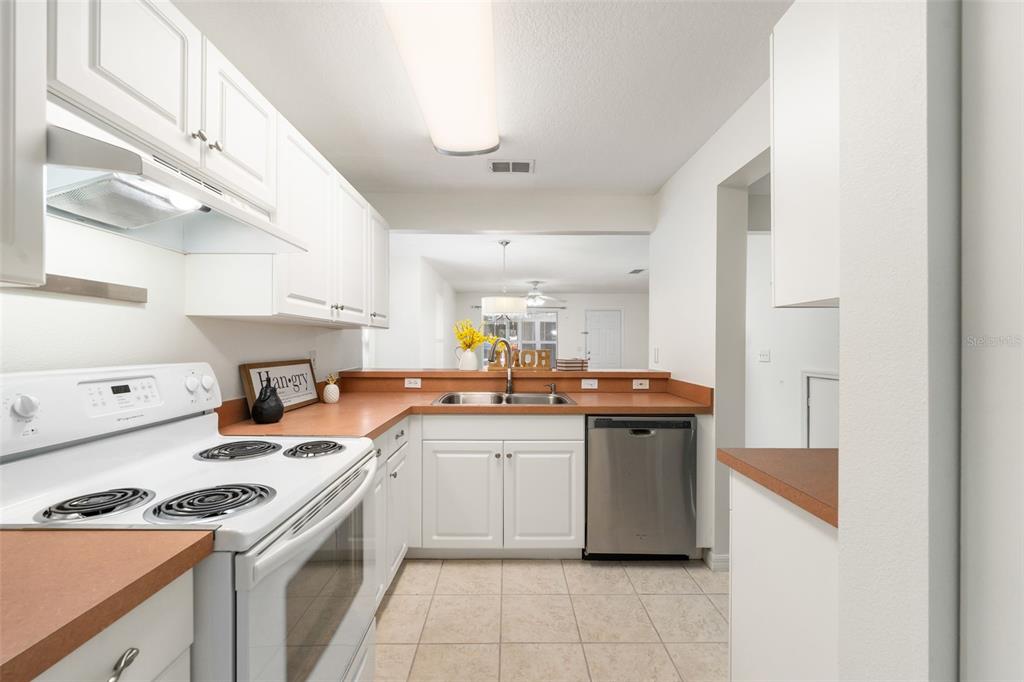 2348 Southwest 42nd Drive, Unit 154 Gainesville, FL 32607 - Photo 16 of 35 a kitchen with a sink stove and cabinets