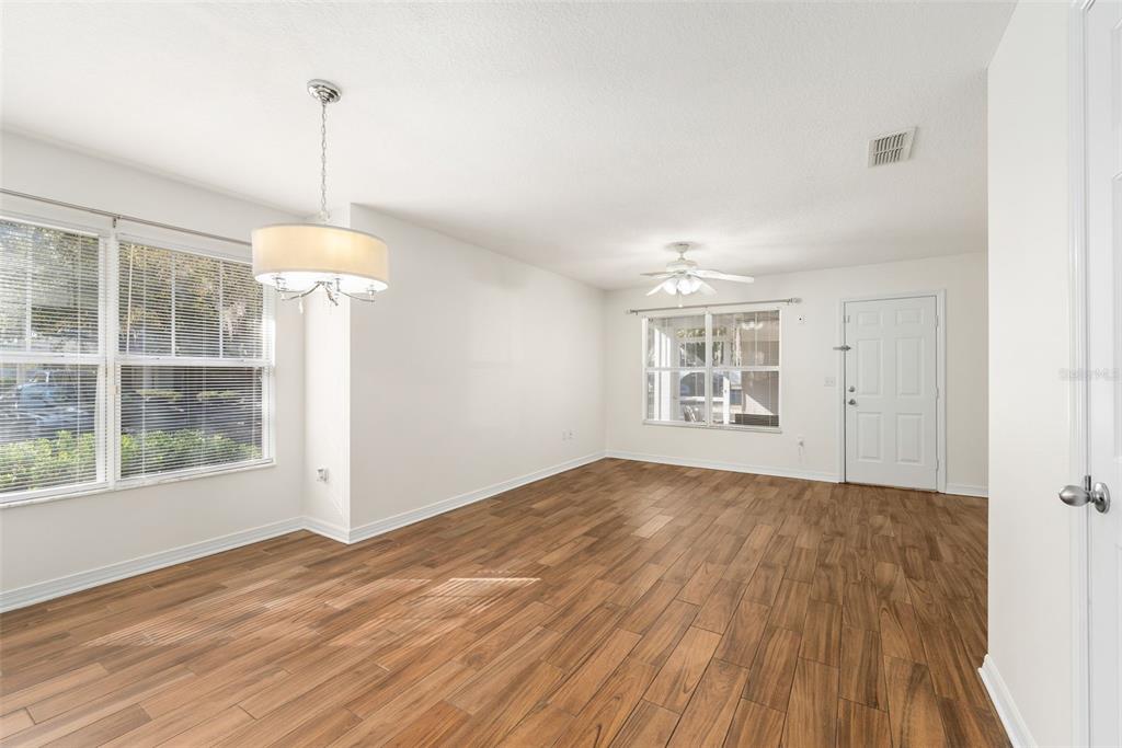 2348 Southwest 42nd Drive, Unit 154 Gainesville, FL 32607 - Photo 18 of 35 a view of empty room with wooden floor and windows