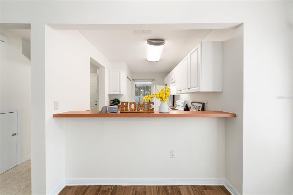 2348 Southwest 42nd Drive, Unit 154 Gainesville, FL 32607 - Photo 20 of 35 a kitchen with a sink a stove and cabinets
