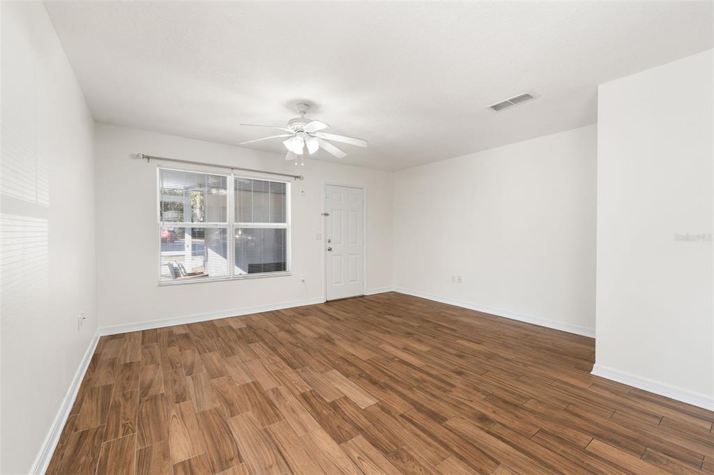 2348 Southwest 42nd Drive, Unit 154 Gainesville, FL 32607 - Photo 21 of 35 a view of empty room with wooden floor and fan