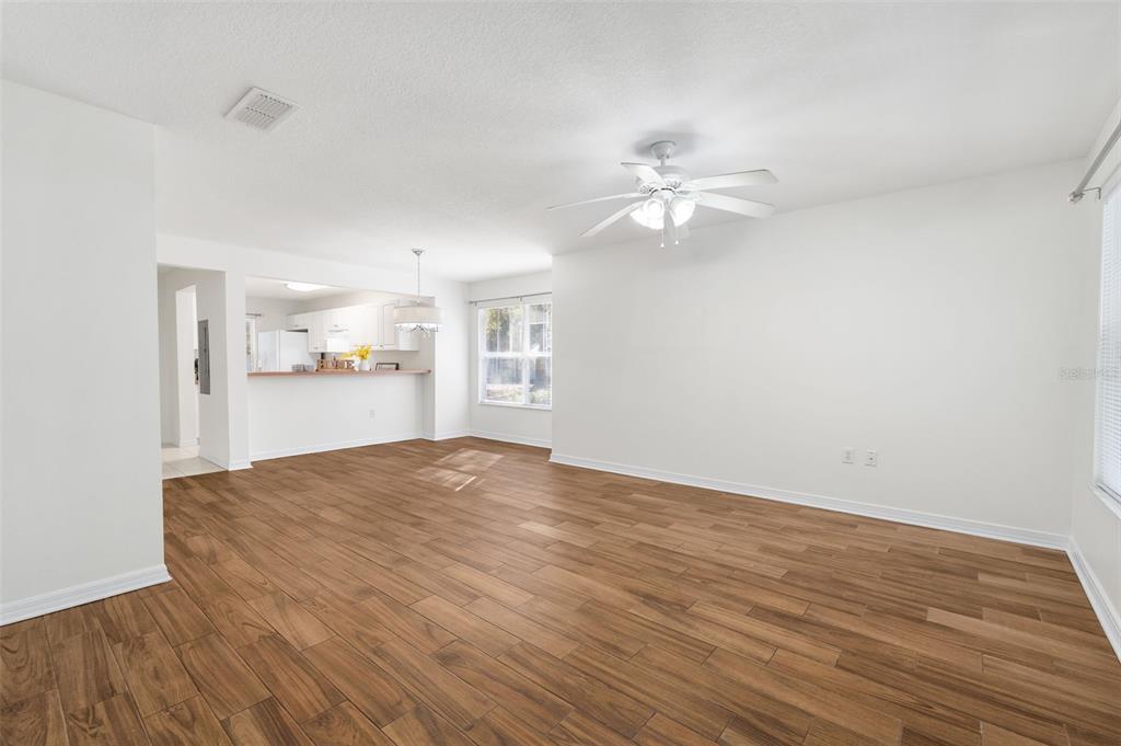 2348 Southwest 42nd Drive, Unit 154 Gainesville, FL 32607 - Photo 22 of 35 a view of a kitchen with wooden floor and a ceiling fan
