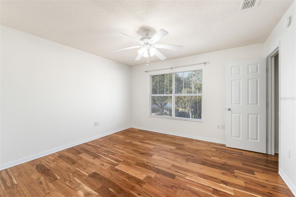 2348 Southwest 42nd Drive, Unit 154 Gainesville, FL 32607 - Photo 6 of 35 wooden floor in an empty room with a window
