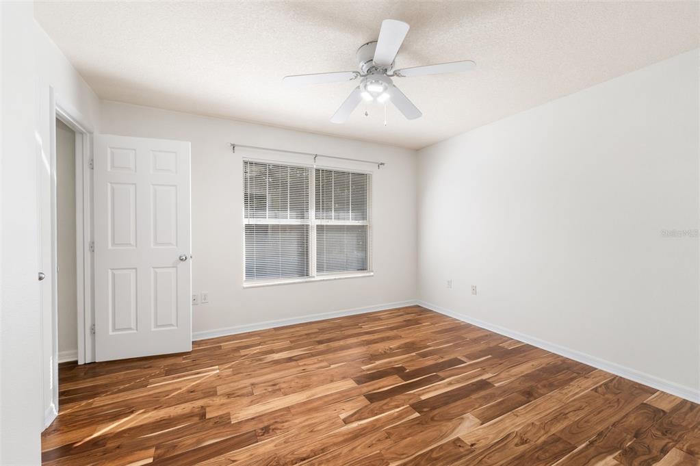 2348 Southwest 42nd Drive, Unit 154 Gainesville, FL 32607 - Photo 10 of 35 a view of empty room with wooden floor and fan
