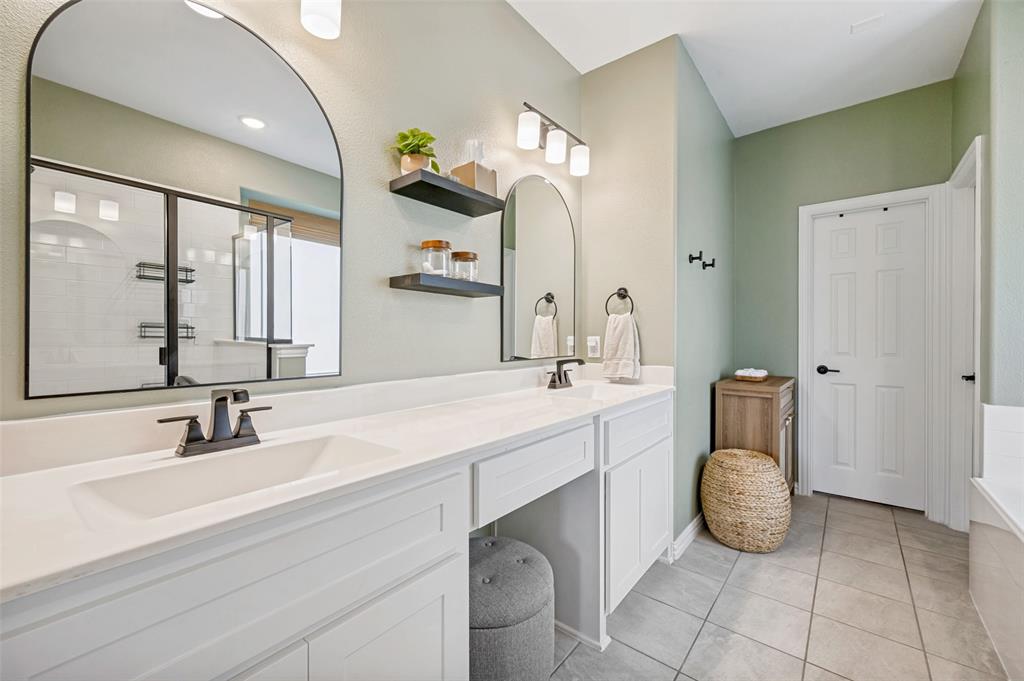 808 Violet Way Celina, TX 75009 - Photo 13 of 30 Primary bathroom with double sinks, a makeup vanity, and black fixtures.
