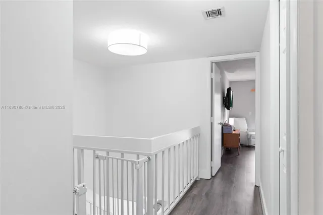 a bedroom with a bed couch and a large window