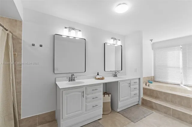 a bathroom with a double vanity sink mirror and toilet