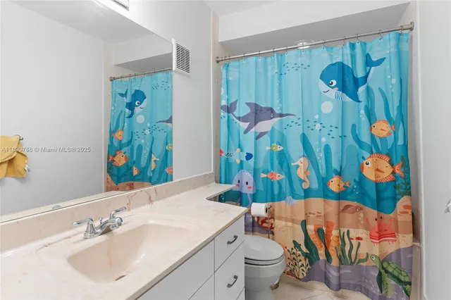 a view of walk in closet with clothes