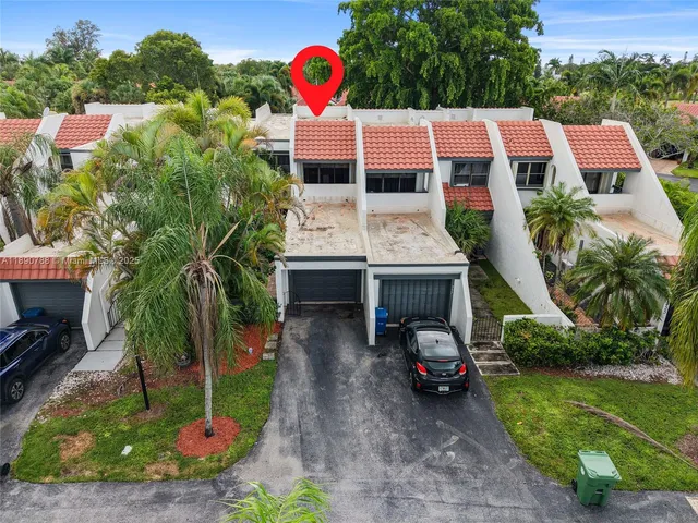 an aerial view of house with yard and outdoor seating