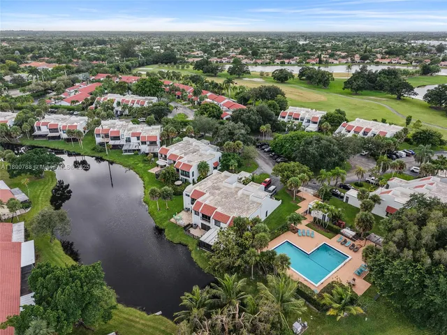 an aerial view of a golf course with a lake view