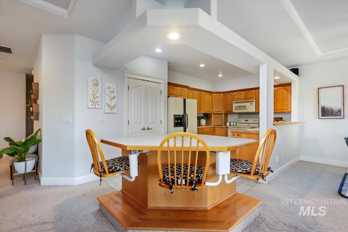 25074 The Driving Lane Caldwell, ID 83607 - Photo 5 of 32 Dining space with light carpet and recessed lighting