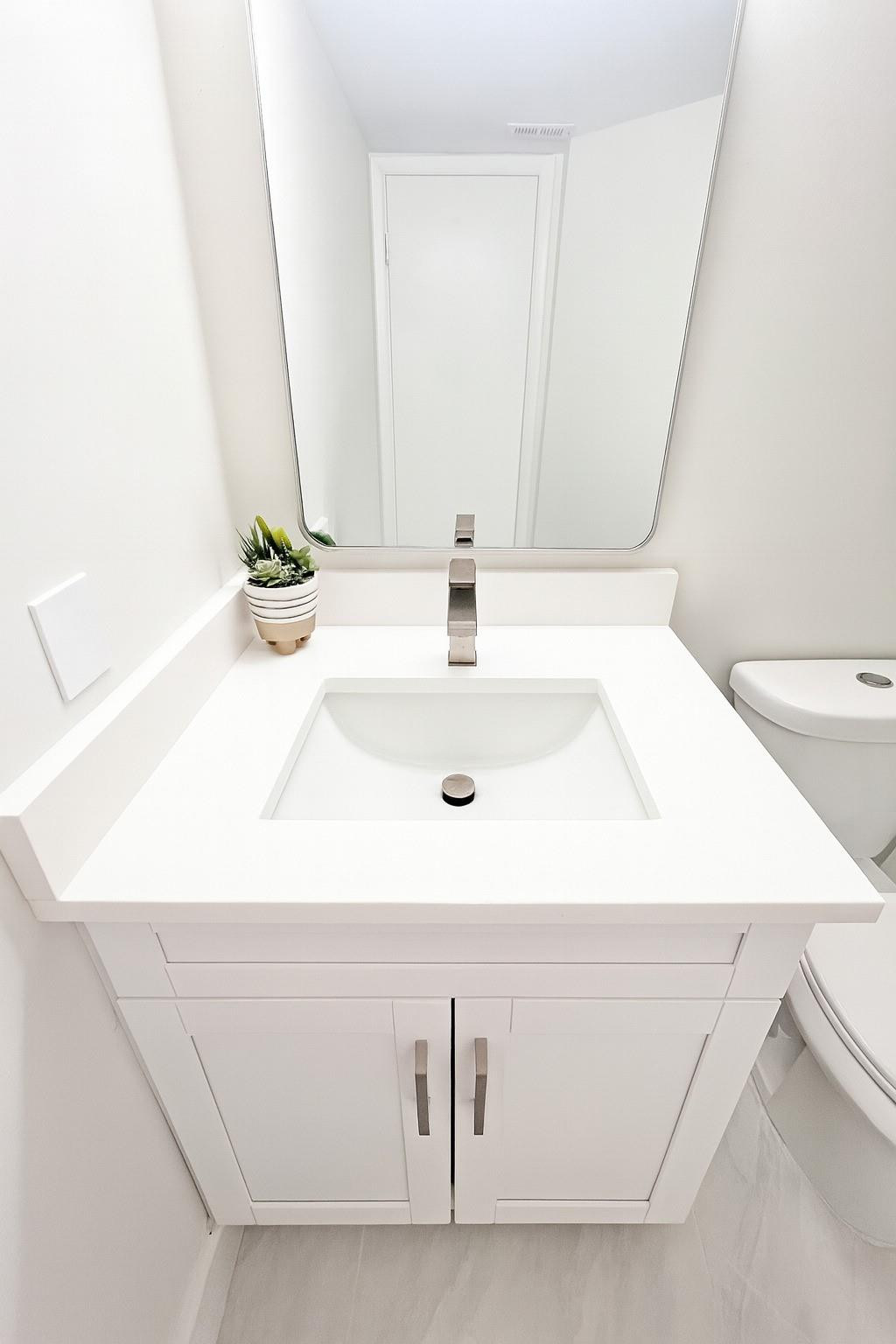 9055 Wiles Road, Unit 208 Coral Springs, FL 33067 - Photo 19 of 35 a bathroom with a sink