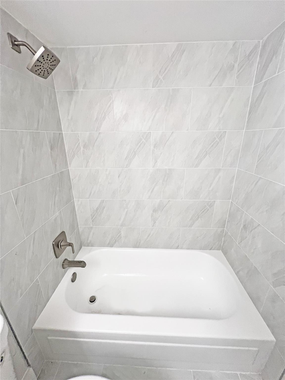 9055 Wiles Road, Unit 208 Coral Springs, FL 33067 - Photo 20 of 35 a bathroom with a bathtub
