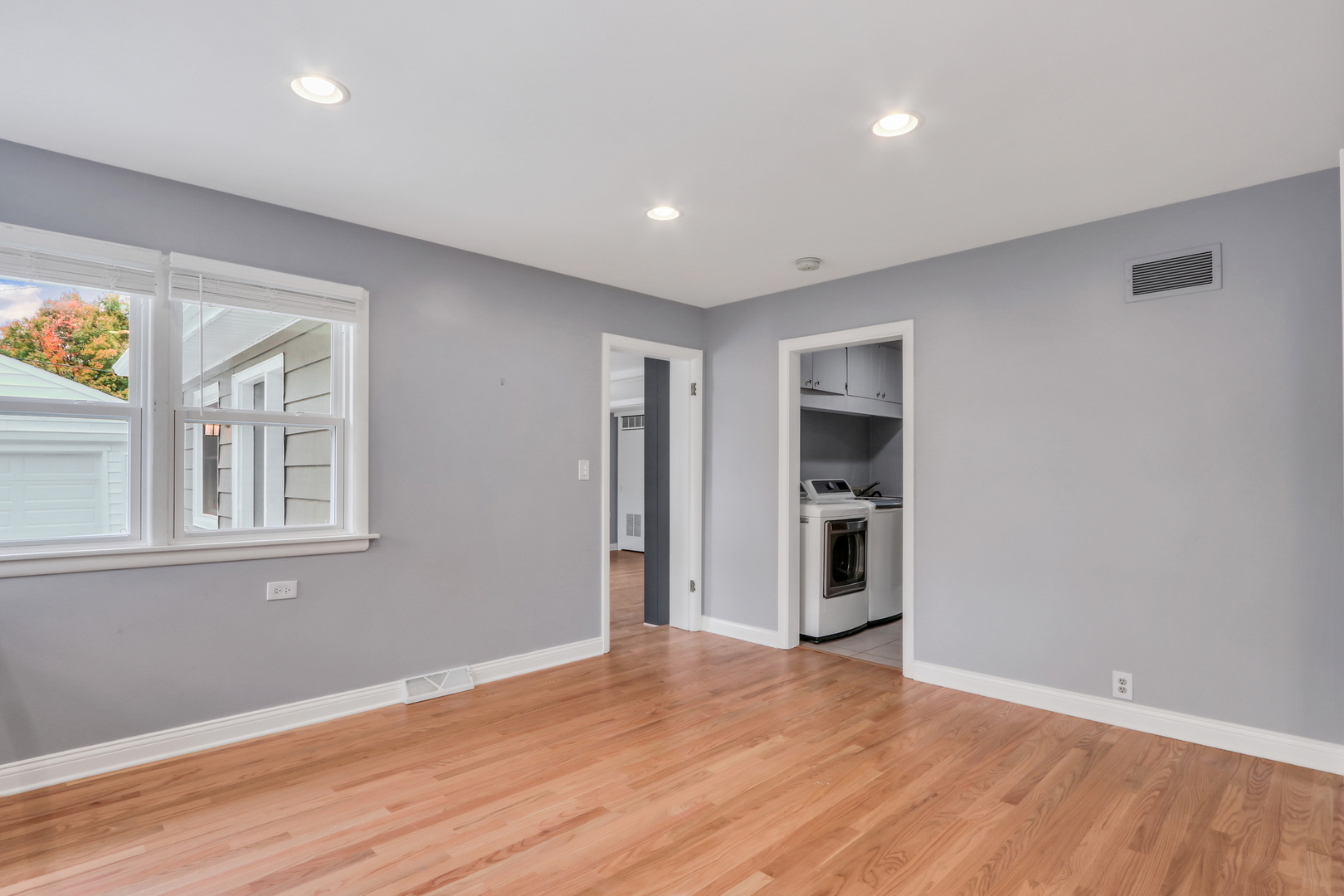 1186 Highland Road Mundelein, IL 60060 - Photo 12 of 28 a view of an empty room with a window and wooden floor