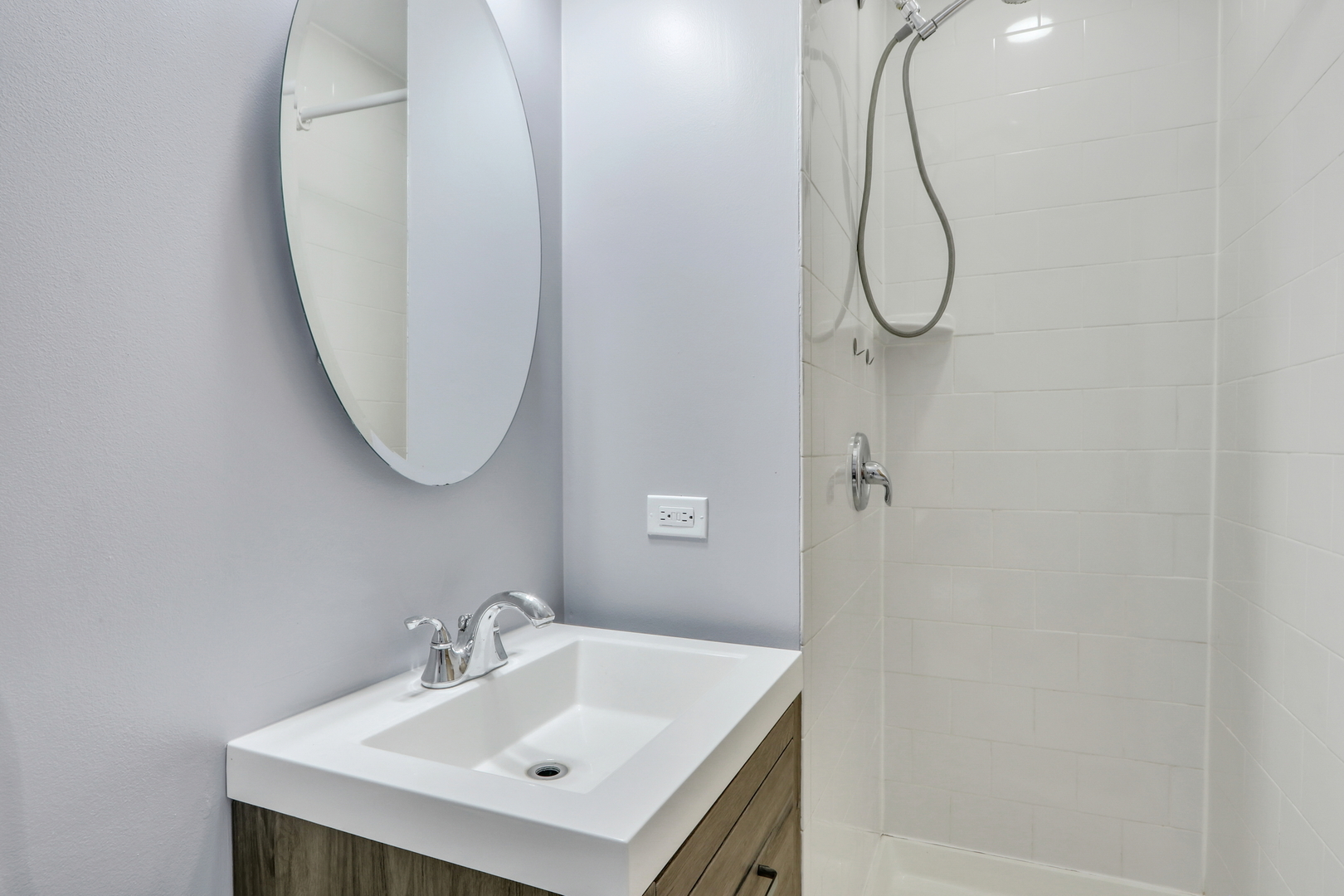 1186 Highland Road Mundelein, IL 60060 - Photo 14 of 28 a bathroom with a sink a mirror and a shower