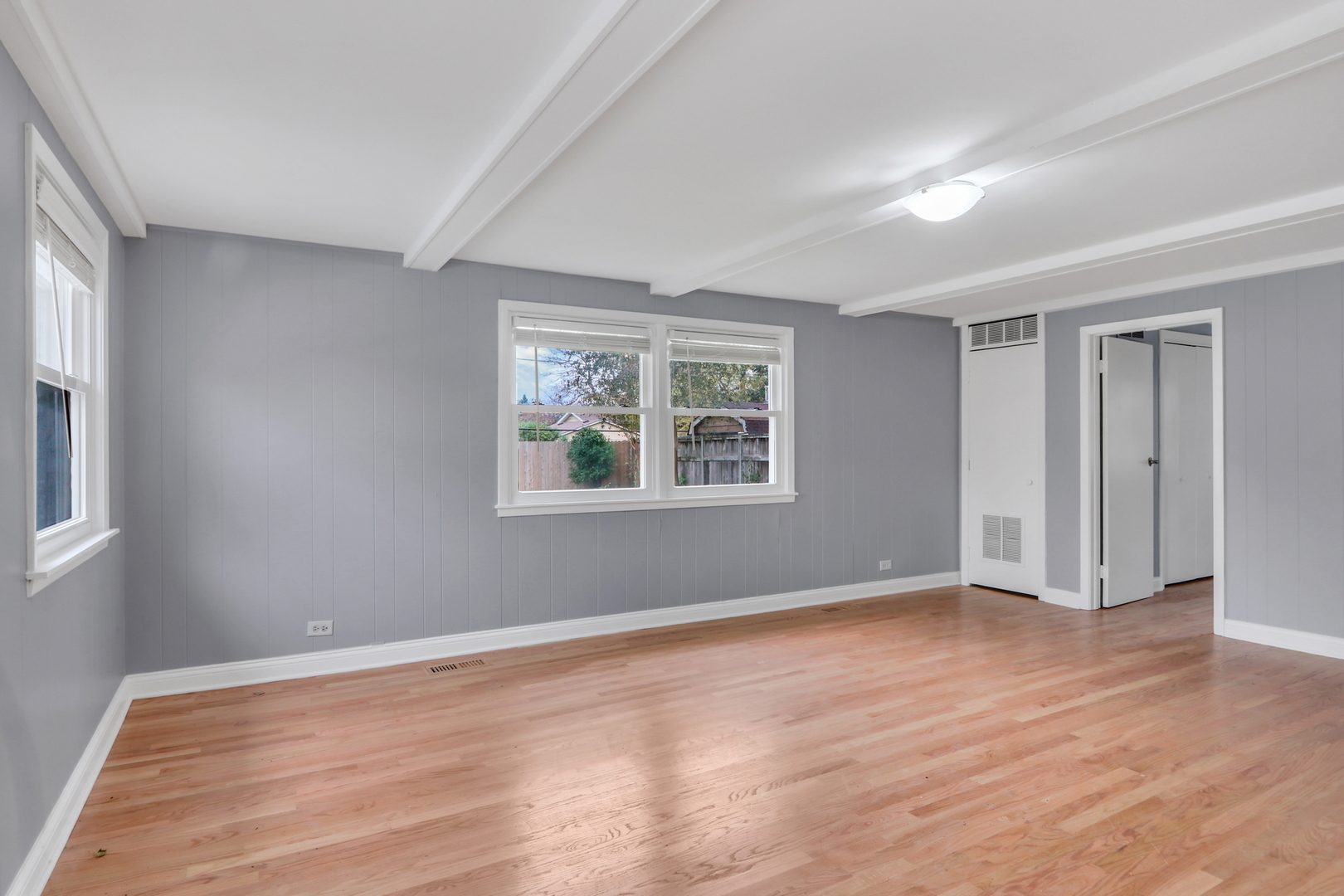 1186 Highland Road Mundelein, IL 60060 - Photo 15 of 28 a view of an empty room with wooden floor and a window