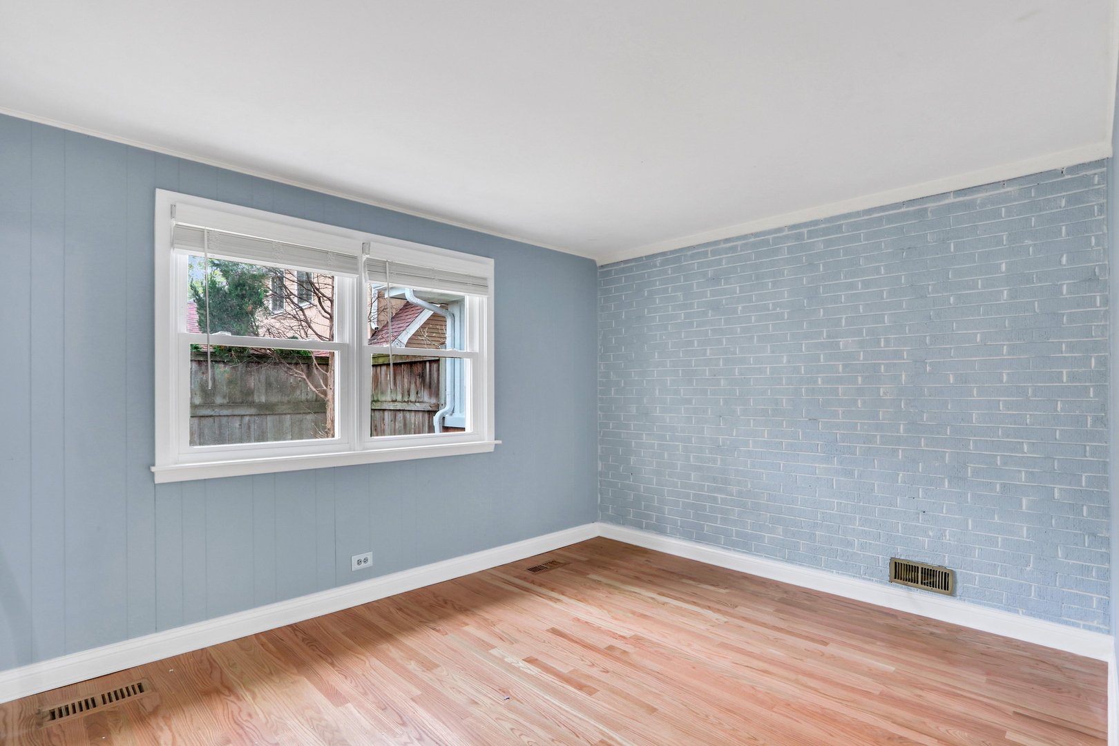1186 Highland Road Mundelein, IL 60060 - Photo 18 of 28 a view of an empty room with wooden floor and a window