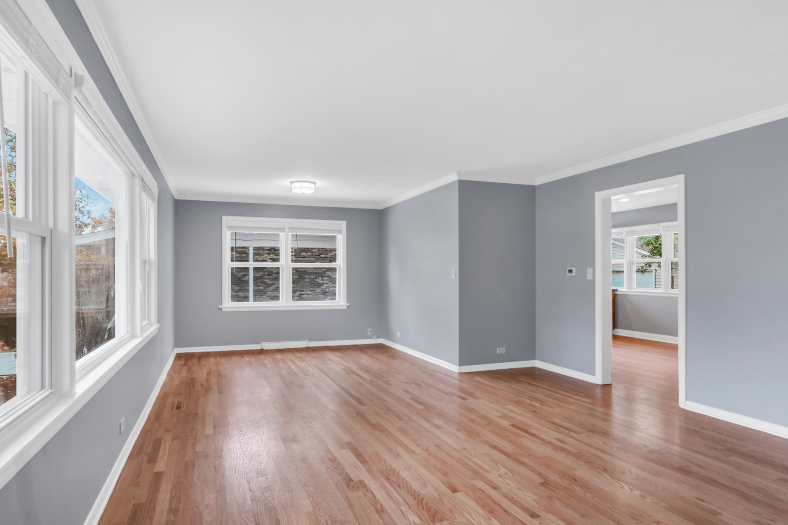 1186 Highland Road Mundelein, IL 60060 - Photo 3 of 28 a view of an empty room with wooden floor and a window