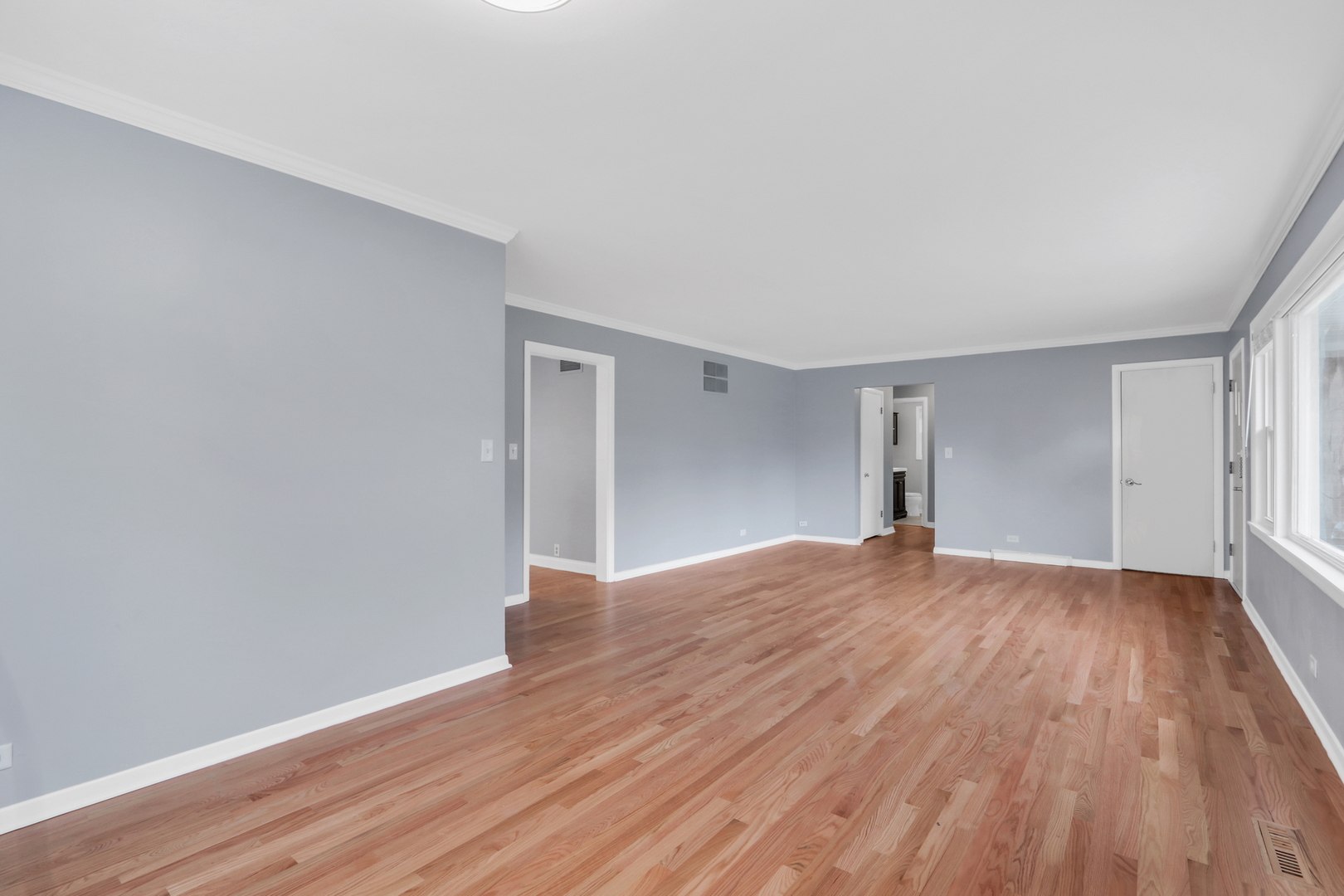 1186 Highland Road Mundelein, IL 60060 - Photo 5 of 28 a view of an empty room with wooden floor and window