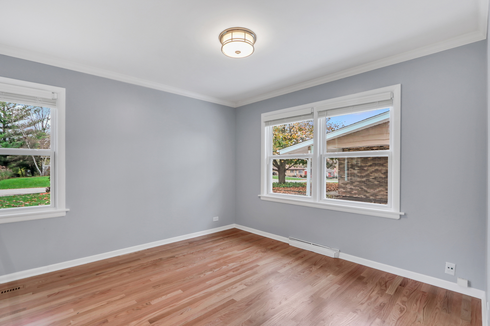 1186 Highland Road Mundelein, IL 60060 - Photo 6 of 28 a view of an empty room with wooden floor and a window