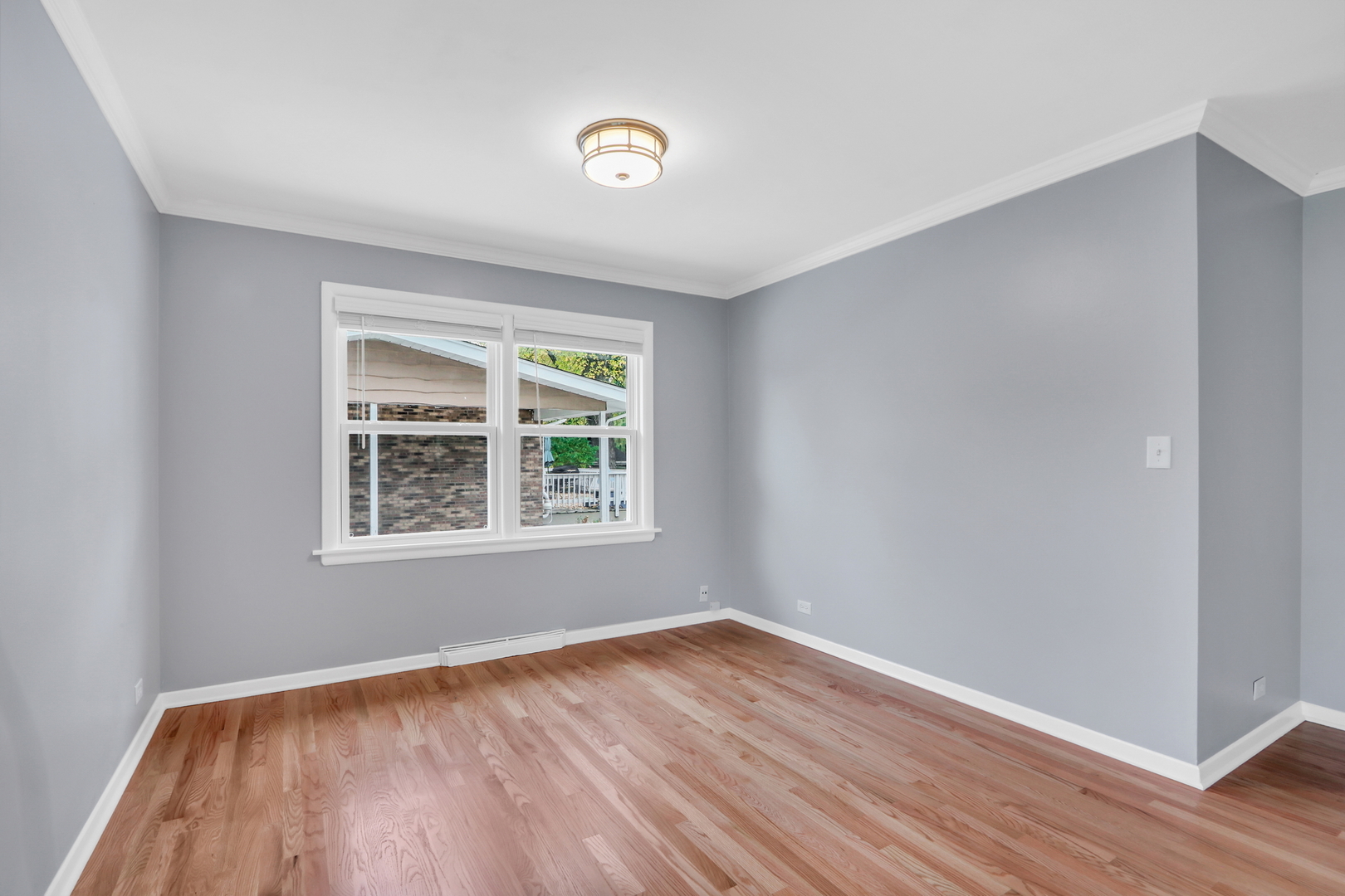 1186 Highland Road Mundelein, IL 60060 - Photo 7 of 28 a view of an empty room with wooden floor and a window