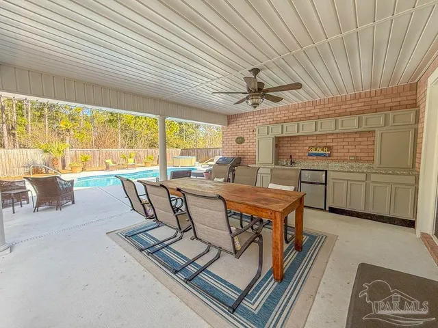 a living room with stainless steel appliances granite countertop furniture and a table