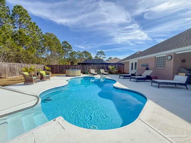 a swimming pool with outdoor seating and city view