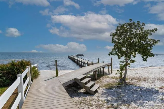a view of a balcony with wooden floor and potted plants